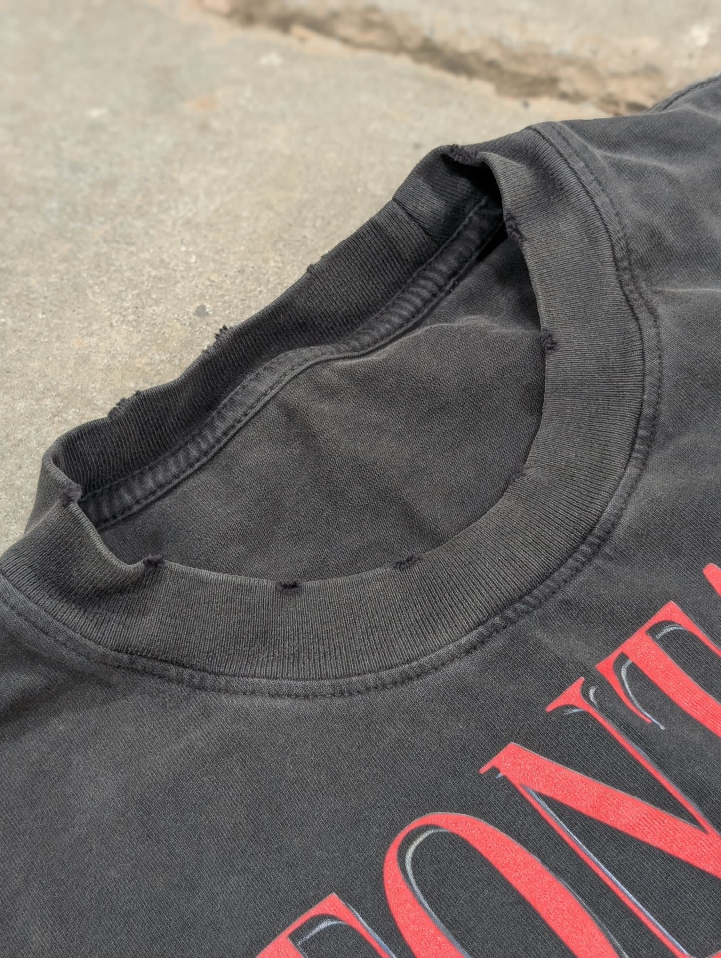 Detail of the distressed ribbed collar on the Drowned Muse tee