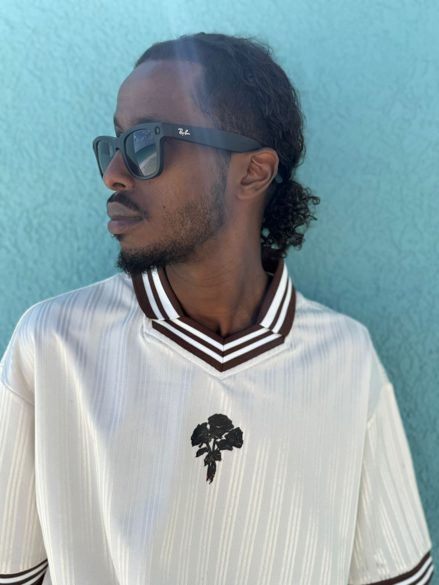 Satin Pinstripe Polo worn front view, black rose chest embroidery and striped rib collar
