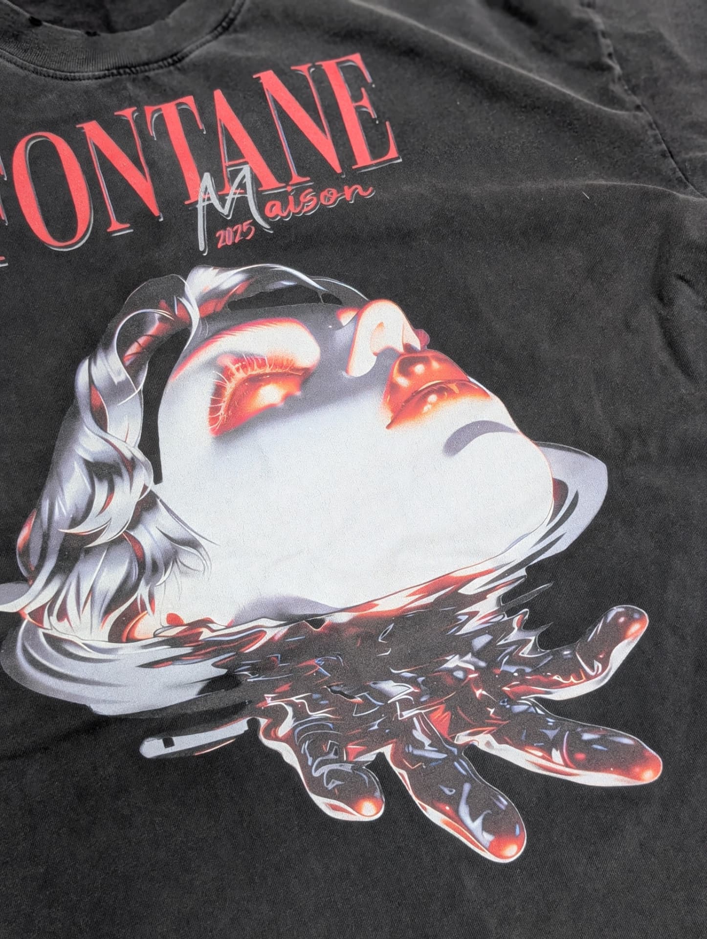 Close detail of the Drowned Muse surrealist graphic in chrome and crimson